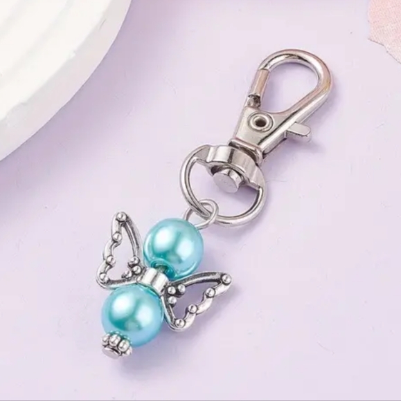 Pearlized angel bag charm NWOT includes box - Picture 3 of 3